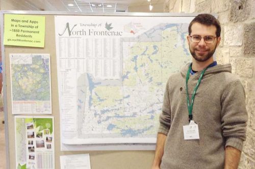 Evan Sepa with the North Frontenac wall map at the URISA – Ontario AGM in Guelph.